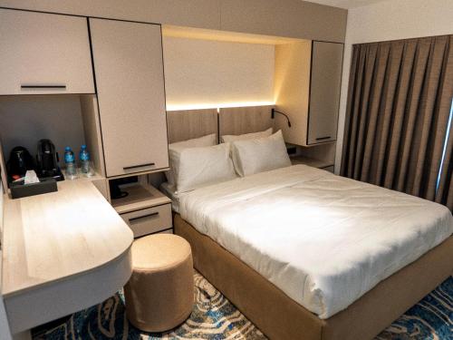 a hotel room with a bed and a sink at Central Square Hotel in Baku