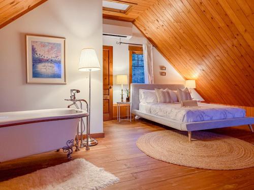 une chambre avec un lit et un plafond en bois dans l'établissement Sara Chalet With Spa Hiking Trails, à Notre-Dame-de-la-Merci
