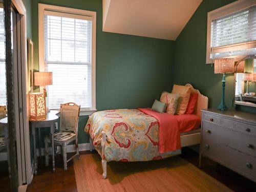 a bedroom with green walls and a bed and a desk at Oceanside Beach Badges Private Yard Wifi Deck Patio Stunning Ocean Side Home In Brant Beach 2Nd Fl Master Suite Has Private Os Shower 13029 in Brant Beach
