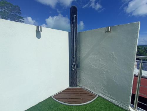 a wall with a shower in the middle of it at Sunset Villa Bora Bora in Bora Bora