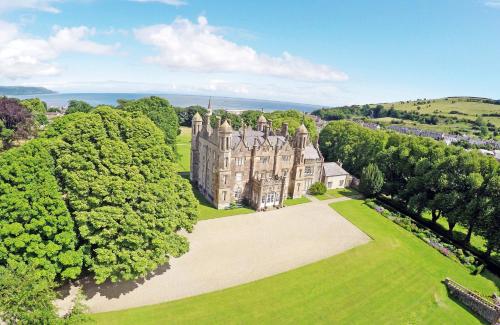 an aerial view of a castle surrounded by trees at The Corner Loft in Ballycastle
