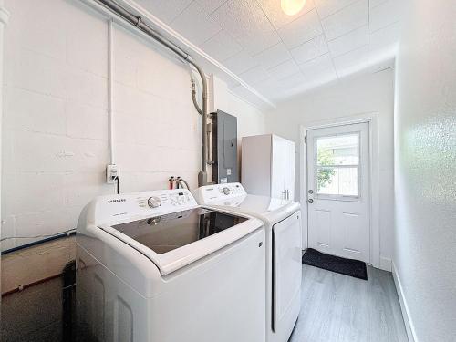 a white laundry room with a washer and dryer at Modern 3BR Retreat with Pool & Fire Pit in Largo