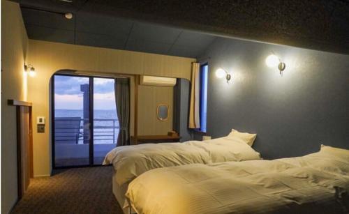 Cama o camas de una habitación en TORIKKA Stay -海だけが見える宿-