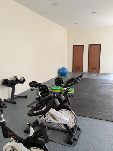 a room with two exercise bikes in a gym at Aqua Horizon Beachside Condo I Signature Art Suites in Dauis