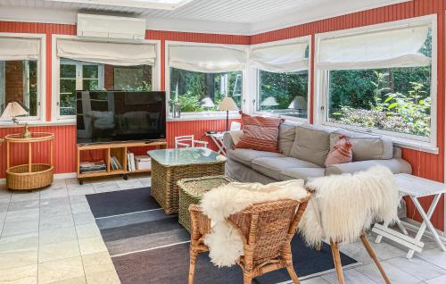 a living room with a couch and a tv at 4 Bedroom Amazing Home In Vejby in Vejby