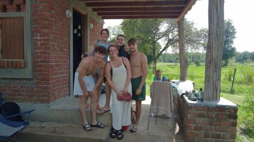 a group of people posing for a picture on a porch at Exciting Tree house and 2 Chalets, Spring valley farm stay Buttala, Okkampitiya 