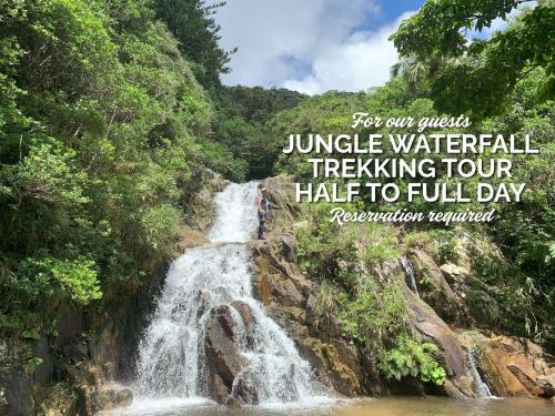 a waterfall in a forest with the words for our jungle waterfalltraveltravel at Océanos - Sunset, BBQ, Beach & Kayak - オケアノス in Ishigaki Island