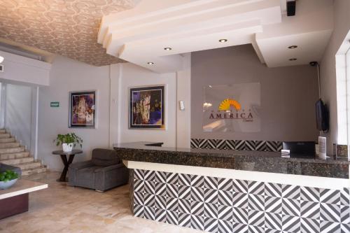 a lobby with a bar in a building at Hotel America Centro in Los Mochis