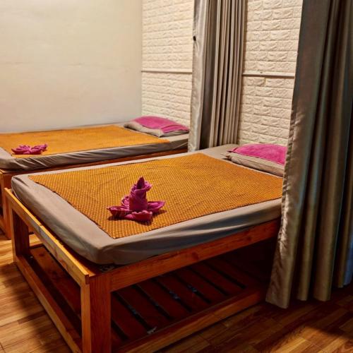 a couple of beds sitting in a room at KM Pool Spa Resort 