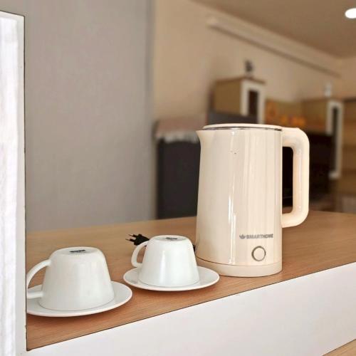 two white appliances sitting on a kitchen counter at KM Pool Spa Resort 