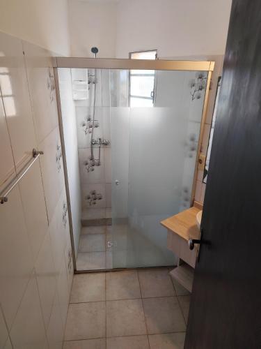 a shower with a glass door in a bathroom at Arenas del Diablo in Punta Del Diablo