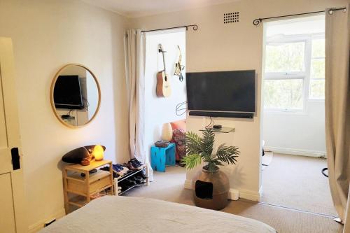 a bedroom with a tv on the wall and a room at Dorje's place - 1 Bedroom plus Study Potts Point Apartment in Sydney