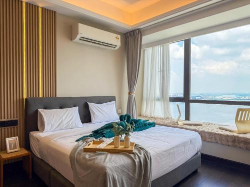 a bedroom with a large bed with a large window at R&F Princess Cove by Nest Home at Johor Bahru in Johor Bahru