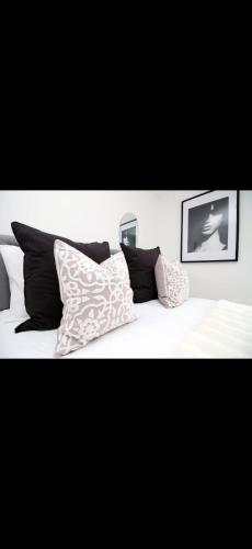 a white bed with pillows on top of it at Luxury Town House in Bristol, Near Southmead Hospital in Bristol