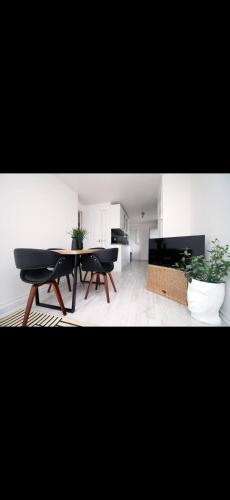 a living room with a table and two chairs at Luxury Town House in Bristol, Near Southmead Hospital in Bristol