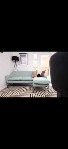 a living room with a couch and a chair at Luxury Town House in Bristol, Near Southmead Hospital in Bristol
