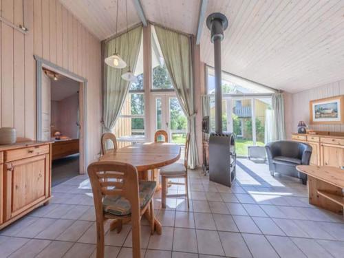 a dining room with a wooden table and chairs at Ferienhaus mit Sauna im Ferienpark Mirow in Granzow