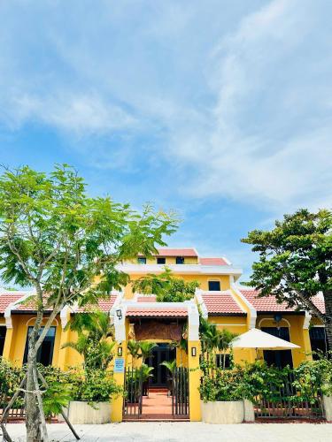 a yellow house with a gate in front of it at Laa House in Hoi An