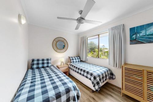una camera da letto con due letti e una finestra di 6 Pelican Beach Resort a Noosaville