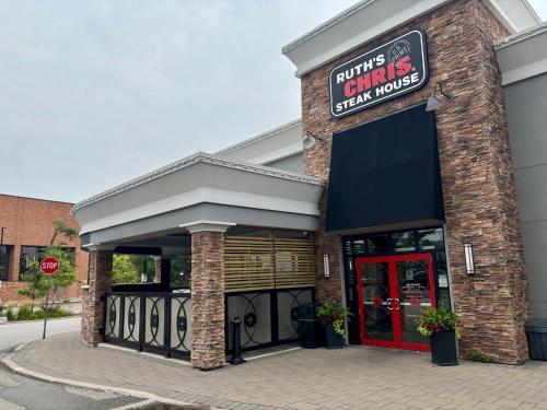 a dunkin donuts restaurant with a red door at Holiday Inn Toronto International Airport by IHG in Toronto