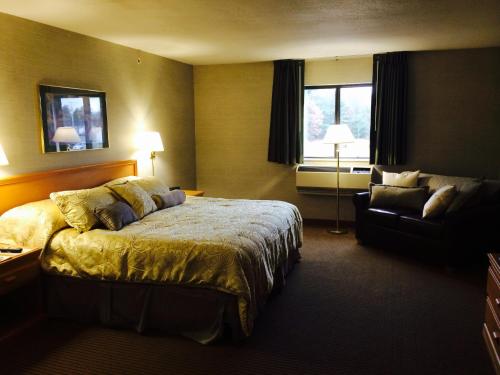 a hotel room with a bed and a couch at All Seasons Resort in Kalkaska