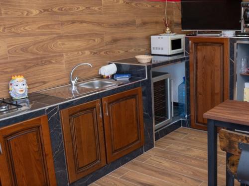 a kitchen with a sink and a microwave at Villa Rosa in Contursi
