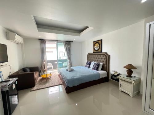 a bedroom with a bed and a couch at W-9 Hotel in Nong Prue