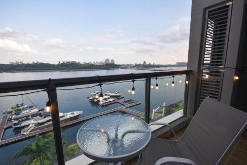 a balcony with a table and a view of a river at R&F Princess Cove by Nest Home at Johor Bahru in Johor Bahru