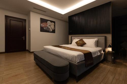 a bedroom with a large bed in a room at Luxhome Mekong Hotel in Can Tho