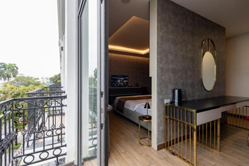 a hotel room with a bed and a balcony at Luxhome Mekong Hotel in Can Tho