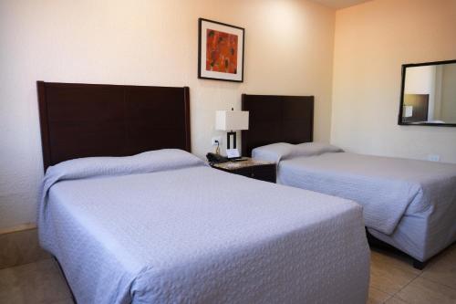 Postel nebo postele na pokoji v ubytování Hotel America Palacio