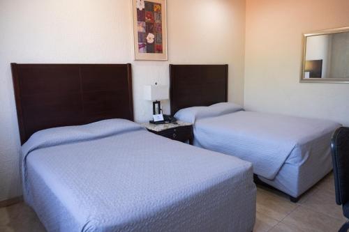 Postel nebo postele na pokoji v ubytování Hotel America Palacio