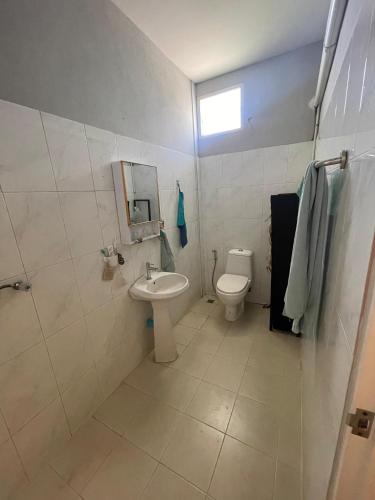 a bathroom with a toilet and a sink at Deli Devi Budget Home in Hinkong