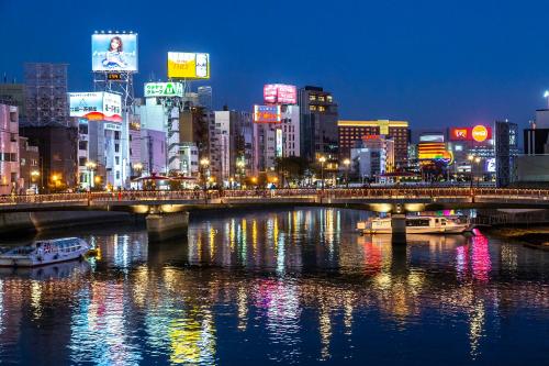 a bridge over a river in a city at night at カトレアコーポ美野島 in Sumiyoshi