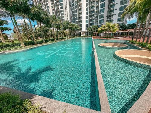 a large swimming pool with palm trees and buildings at Starry C13 at Green Haven 2Bedroom 2 Bathrooms in Masai