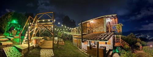 a small house with a staircase in a yard at night at Glamping en Medellín - Kinsho Glamping - Cabaña con Jacuzzi privado in Medellín