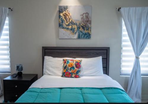 a bedroom with a bed with a pillow on it at Emerald SunDara Villa Ochi in Ocho Rios