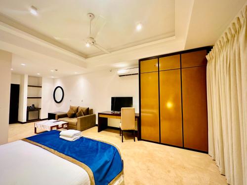 a bedroom with a bed and a living room at Sea view Serenity Negombo in Negombo