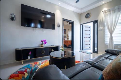 a living room with a couch and a table at Emerald SunDara Villa Ochi in Ocho Rios