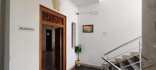 a staircase in a building with a sign on the wall at La Tamara Luxury - TIE Hotels & Resorts in Pondicherry