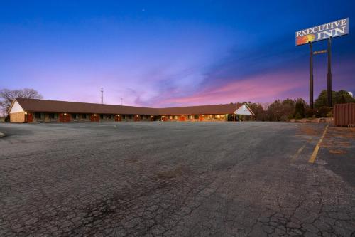 an empty parking lot in front of a building at Budget Host Inn by Hotel O Portland near I-65 in Portland