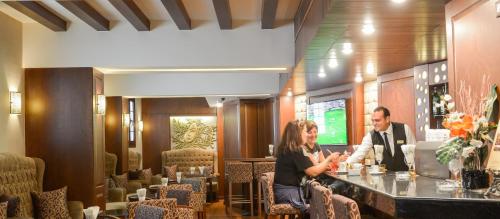 two people sitting at a bar in a restaurant at Hotel Flamenco Cairo in Cairo