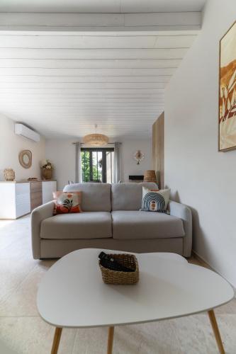 a living room with a couch and a table at Maison Billy - Maison design et climatisée avec jardin in Billy