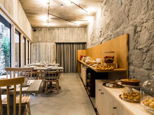a kitchen with a counter and a table with food at Armazém Luxury Housing- Architectural & Design Hotel in Porto
