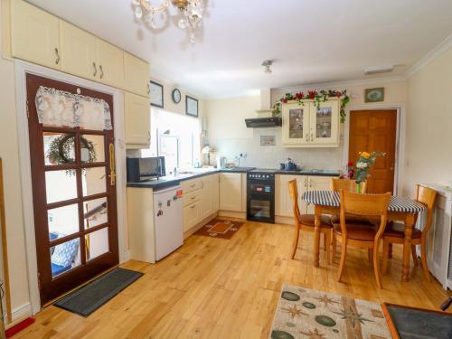 a kitchen with a table and a dining room at Waterfall House in Ardcahan Bridge