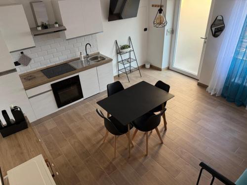 a kitchen with a table and chairs and a sink at B&b da Chiazza 