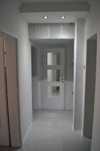 an empty hallway with a door in a building at ARSS Apartment Skopje Main Square in Skopje