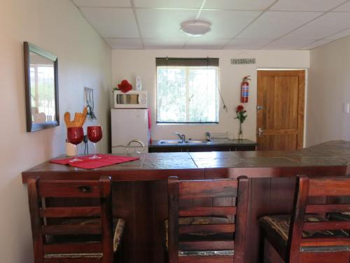 a kitchen with a large wooden island with a counter top at A Cherry Lane Self Catering and B&B in Bloemfontein