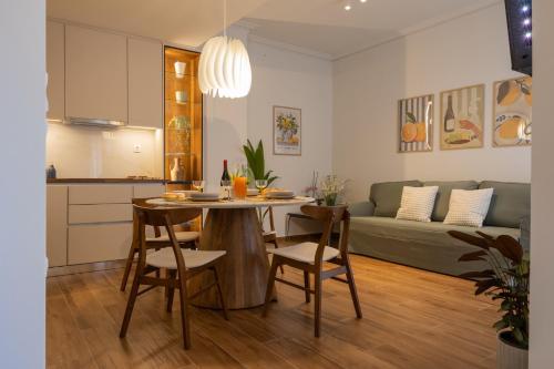 a kitchen and a living room with a table and chairs at Casa Di Sabbia Air-bnb in Nafpaktos