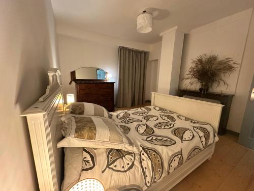 a bedroom with a bed with a comforter on it at Le Milpa LXXXVIII in Brouvelieures